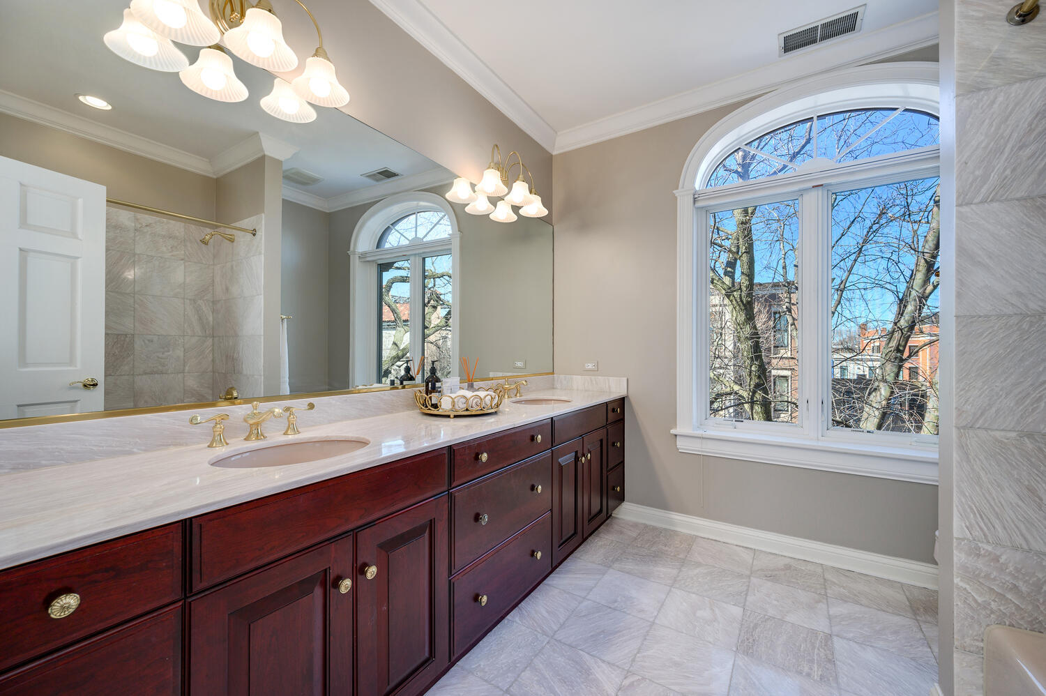 1833 North Howe Street Chicago, IL 60614 - Photo 27 of 41 a spacious bathroom with a granite countertop sink a large mirror a vanity and a bathtub