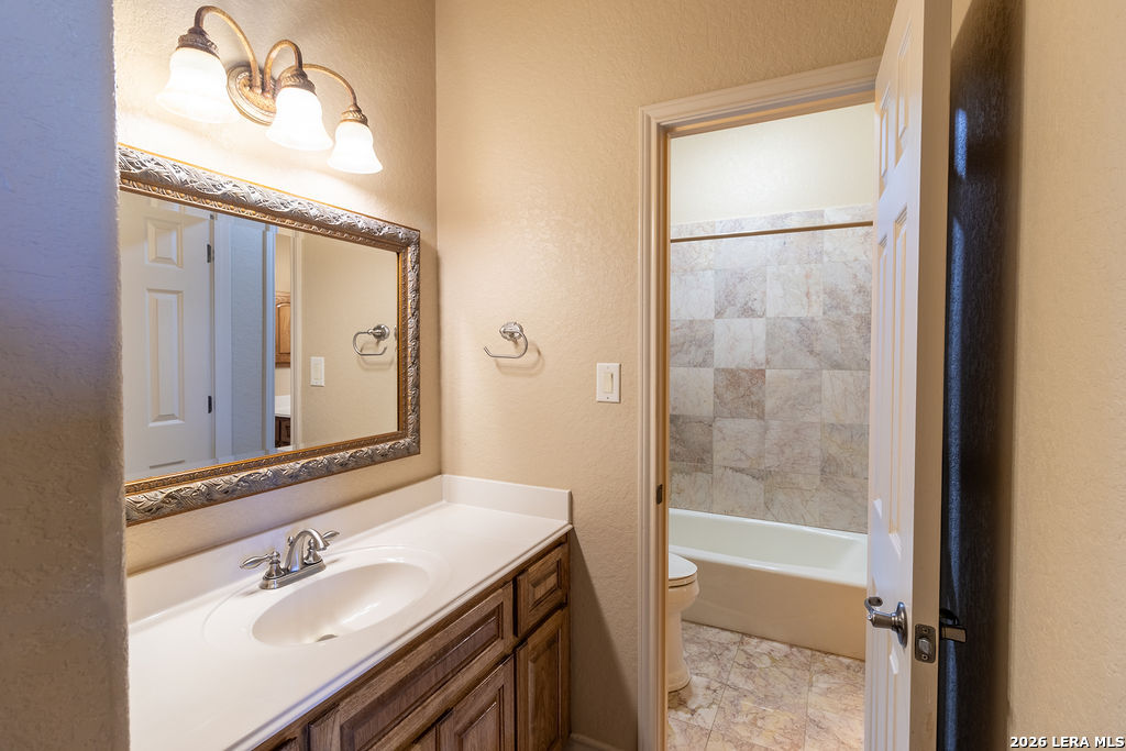 198 Echo Falls Road Comfort, TX 78013 - Photo 18 of 28 a bathroom with a sink and a mirror