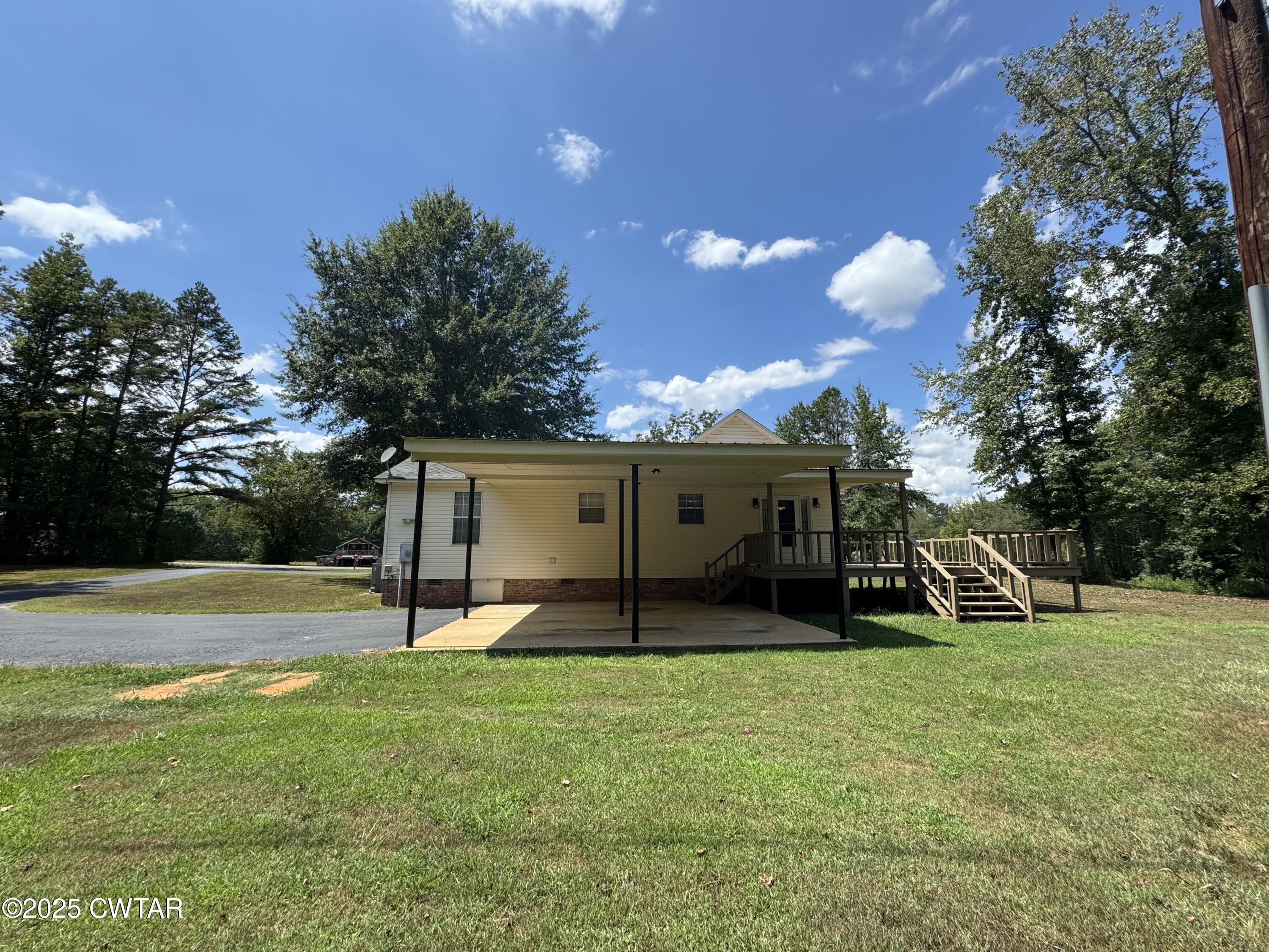 1280 Mockingbird Road Medon, TN 38356 - Photo 11 of 14 a view of a house with backyard and porch