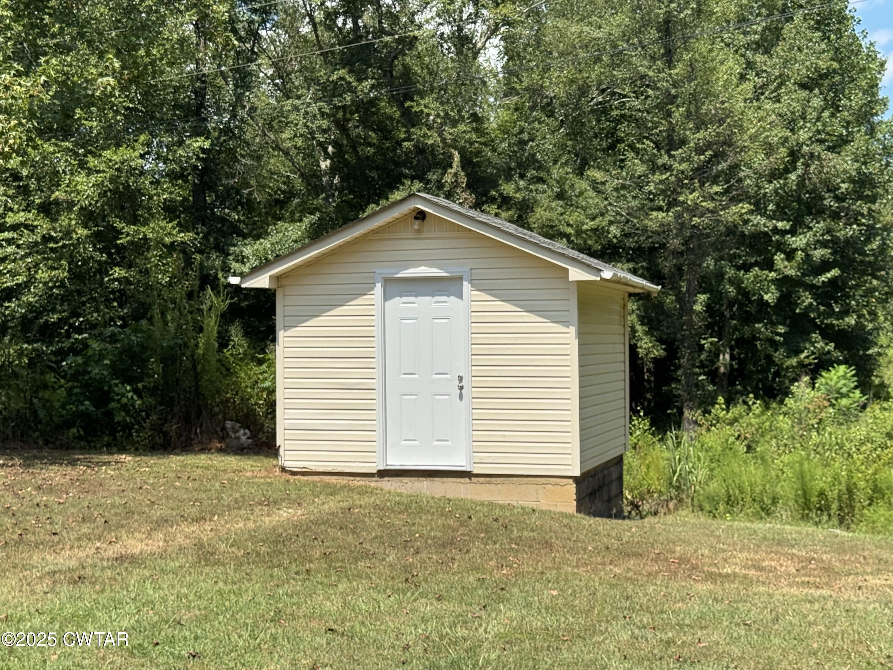1280 Mockingbird Road Medon, TN 38356 - Photo 14 of 14 a front view of a house with a yard