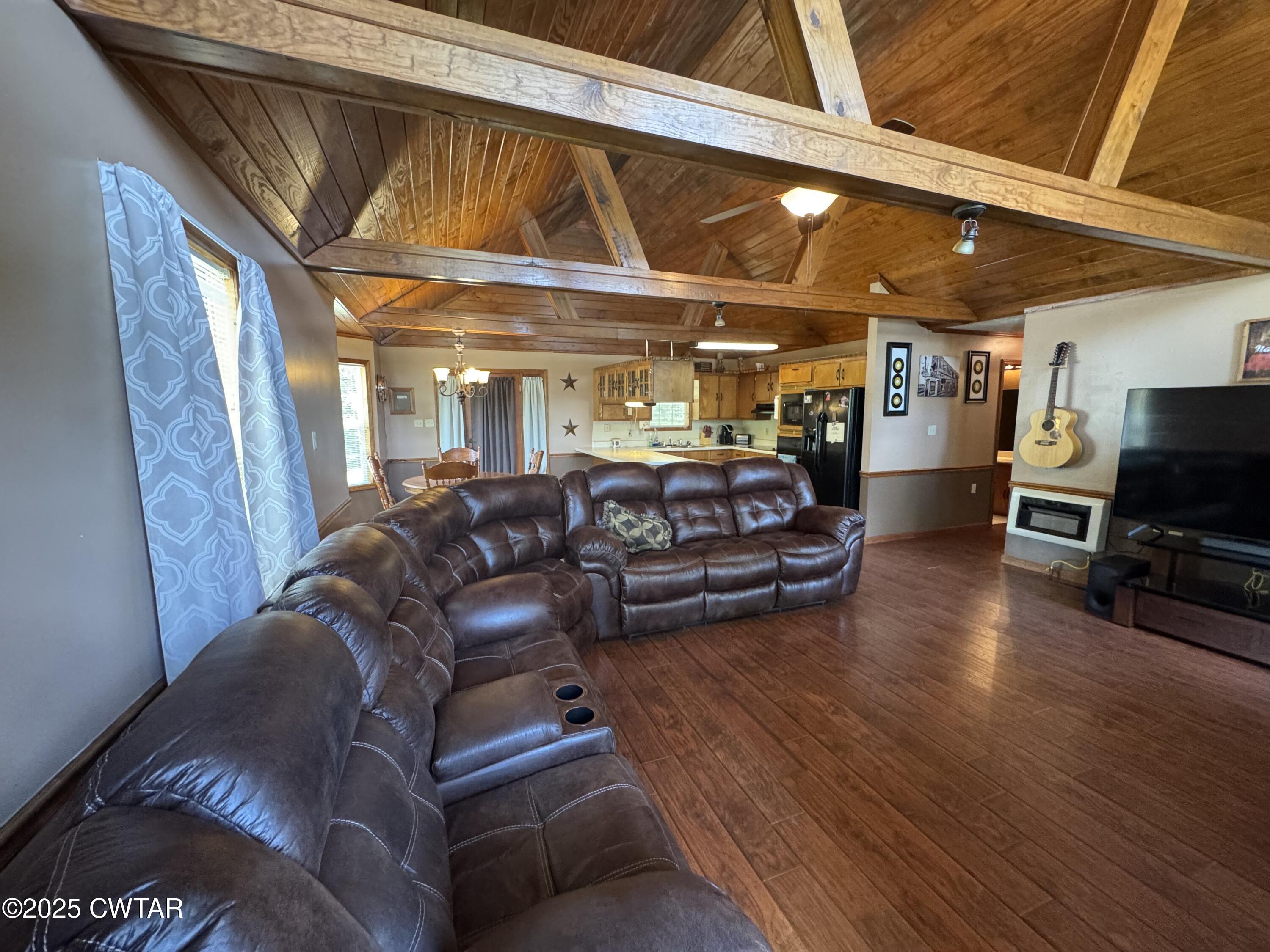 1280 Mockingbird Road Medon, TN 38356 - Photo 2 of 14 a living room with furniture a flat screen tv and kitchen view
