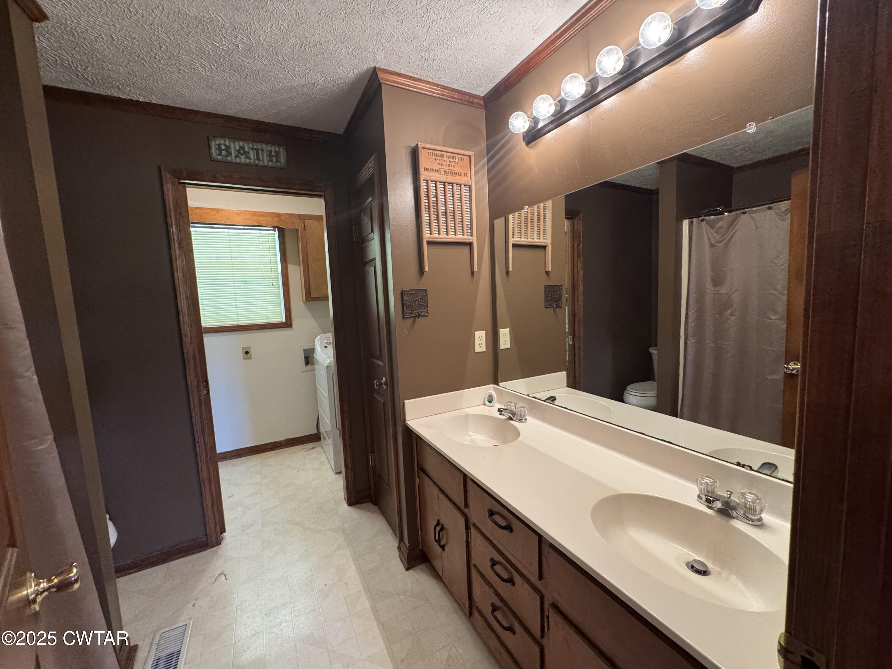 1280 Mockingbird Road Medon, TN 38356 - Photo 8 of 14 a spacious bathroom with a double vanity sink and a mirror