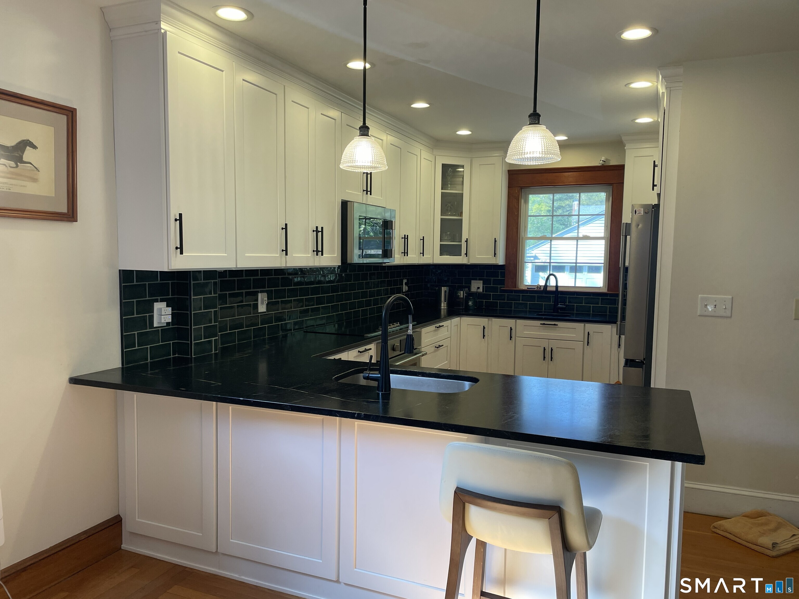 31 Elihu Street Hamden, CT 06517 - Photo 2 of 11 a kitchen with granite countertop white cabinets and a sink