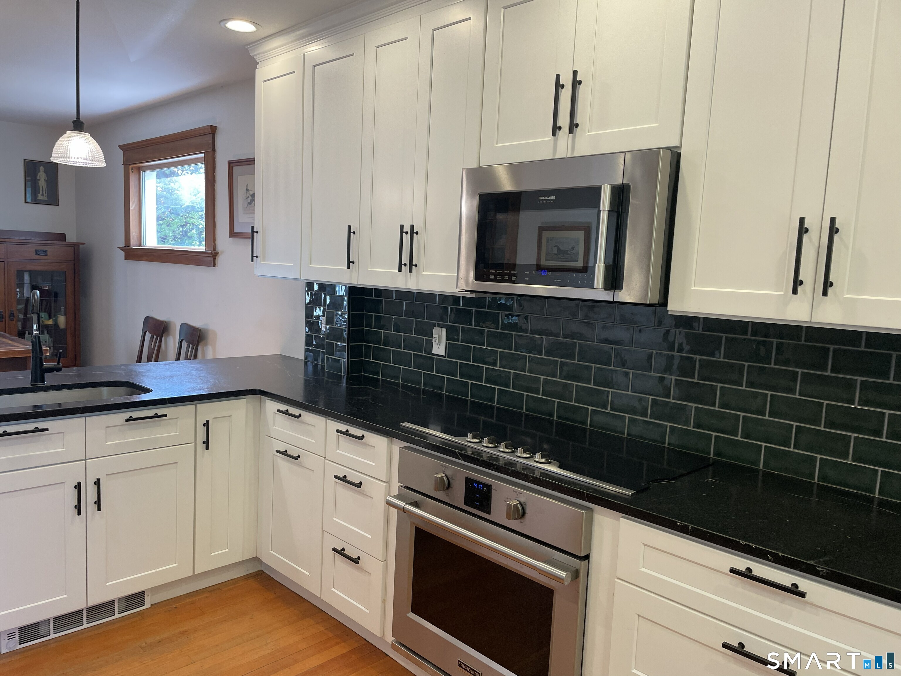 31 Elihu Street Hamden, CT 06517 - Photo 3 of 11 a kitchen with granite countertop white cabinets and black appliances