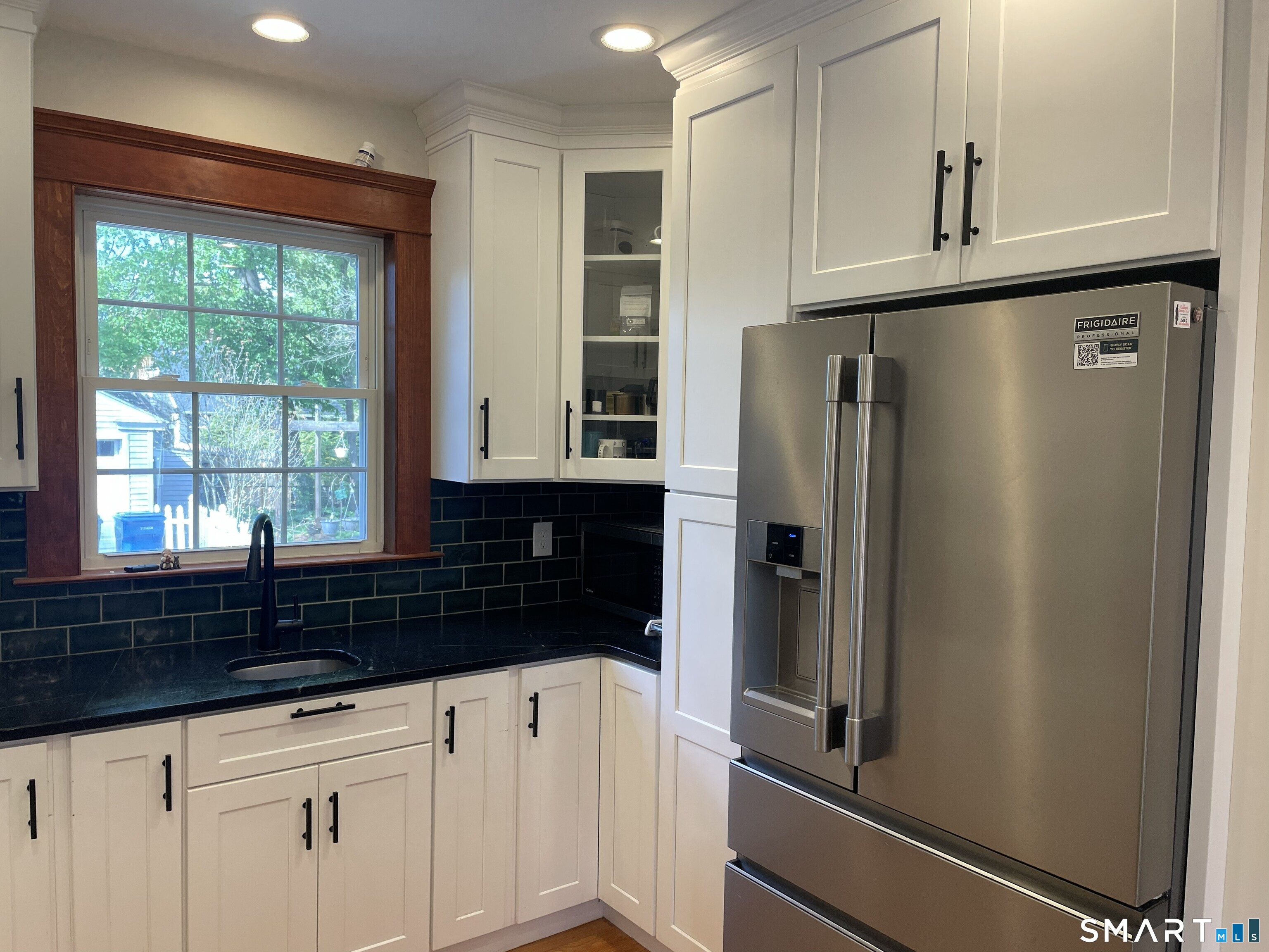 31 Elihu Street Hamden, CT 06517 - Photo 4 of 11 a kitchen with stainless steel appliances granite countertop a refrigerator and a sink