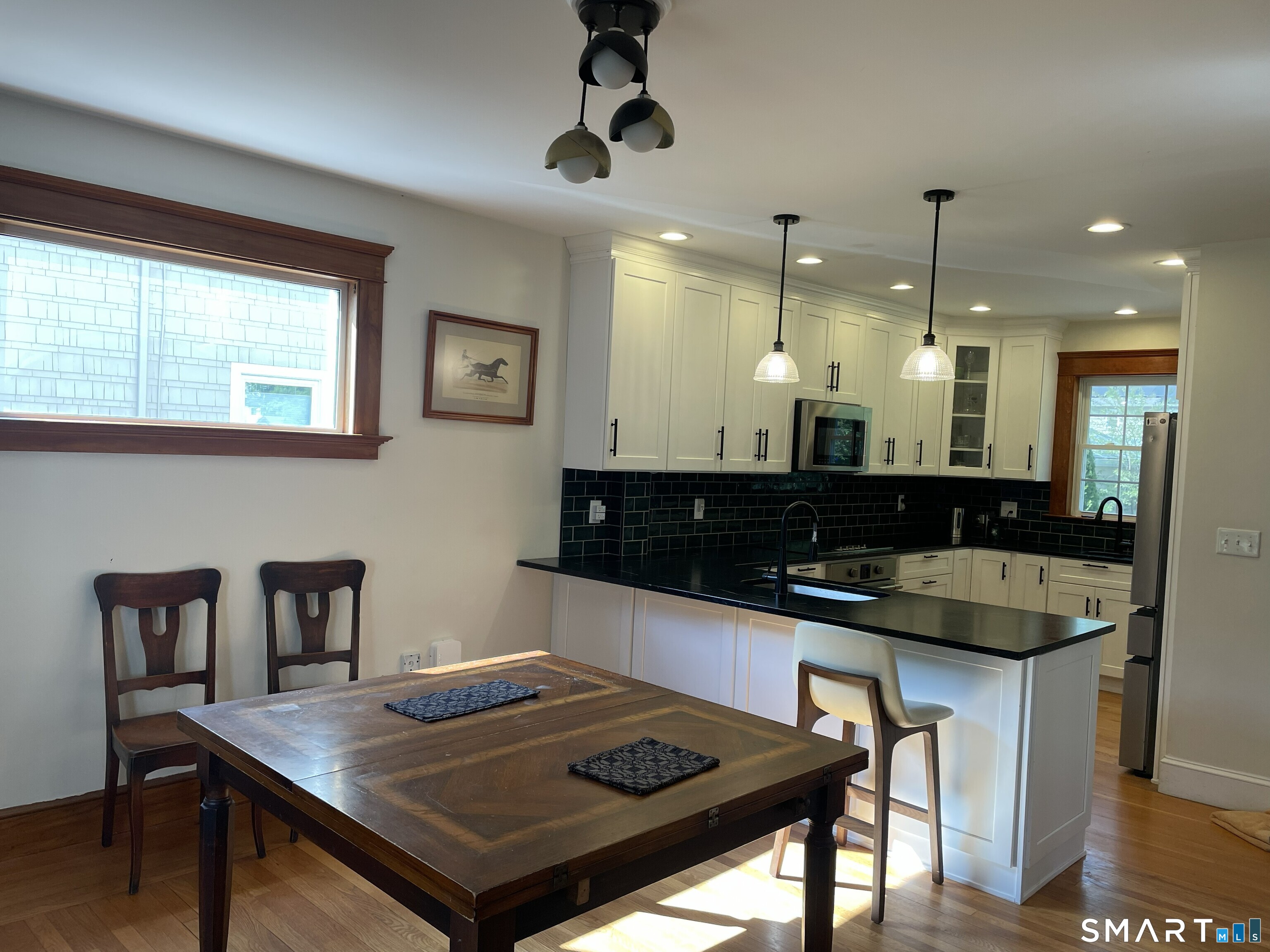 31 Elihu Street Hamden, CT 06517 - Photo 7 of 11 a kitchen with a table a sink and cabinets