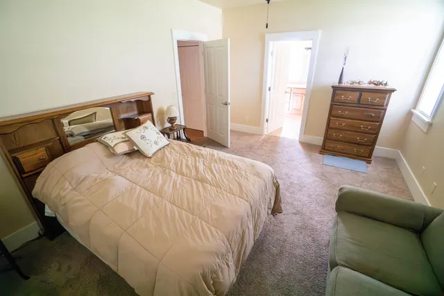 a bedroom with a bed and a couch