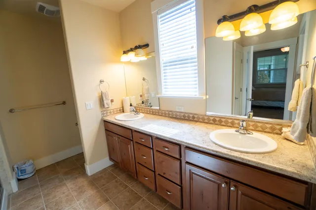 a bathroom with a double vanity sink and a mirror