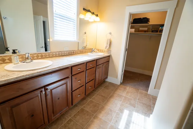 a bathroom with a double vanity sink and mirror