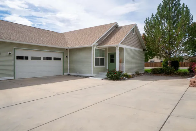 a view of house with outdoor space and parking space