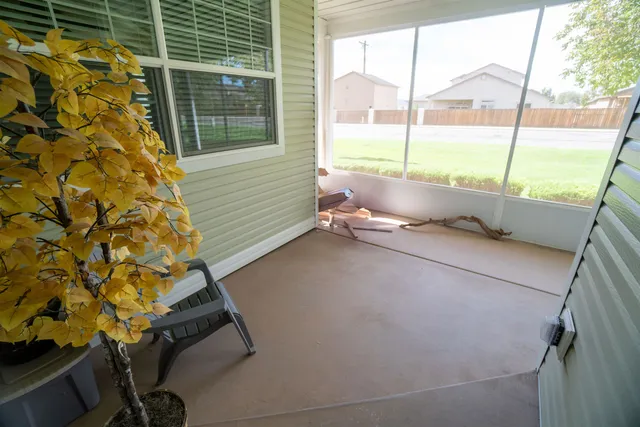 a view of backyard of house with green space
