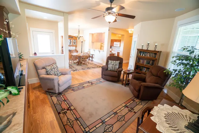 a living room with furniture fireplace and a large window