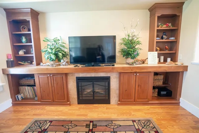 a living room with a fireplace and a flat screen tv