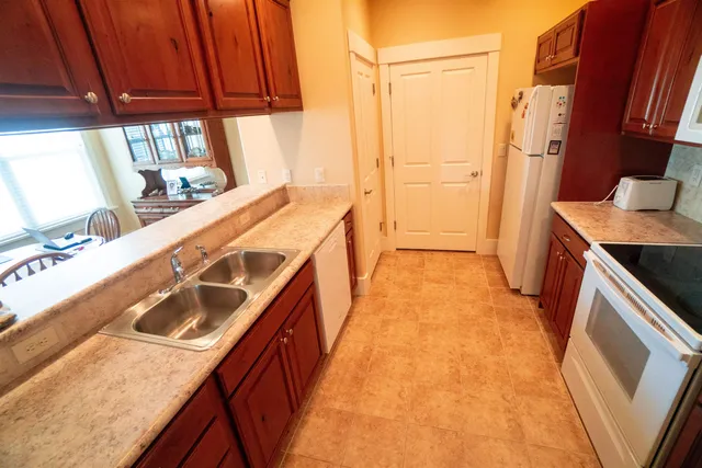 a kitchen with a sink a stove and a refrigerator