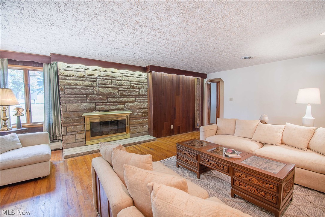 2128 Pressler Road Akron, OH 44312 - Photo 12 of 35 Great room with pristine hardwood floors and a wood-burning fireplace.