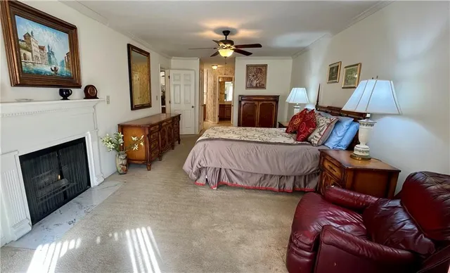 a spacious bedroom with a bed a couch and dresser