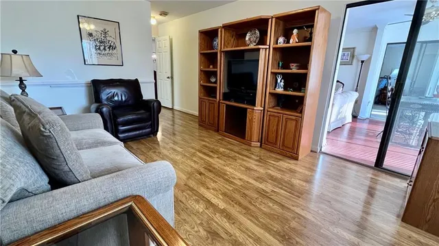 a living room with furniture and a book shelf