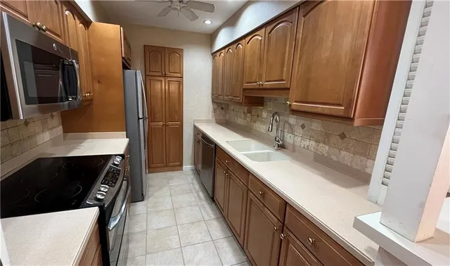 a kitchen with stainless steel appliances a sink stove and refrigerator