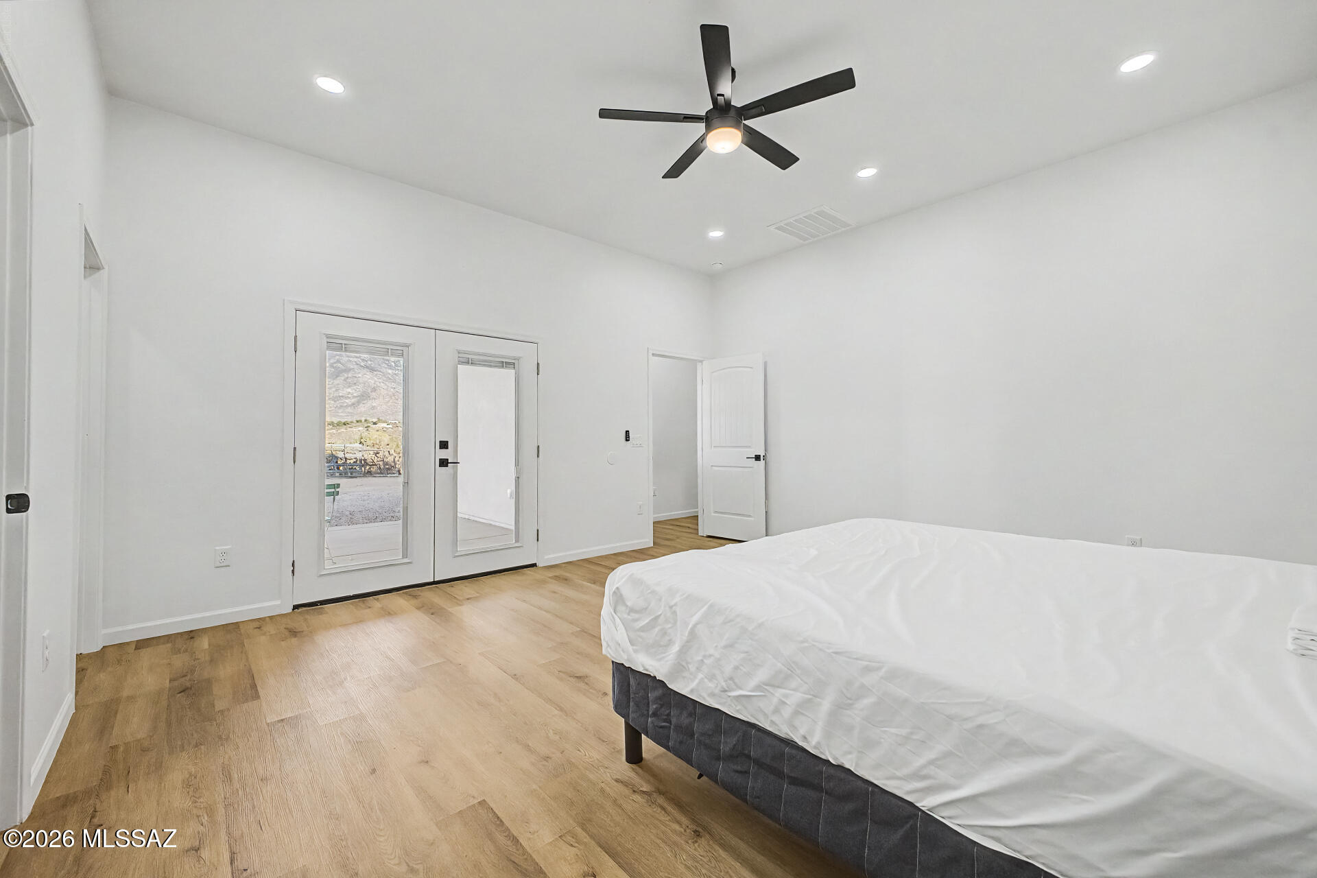 4601 East Magoo Road Tucson, AZ 85739 - Photo 12 of 38 a spacious bedroom with a bed and a ceiling fan