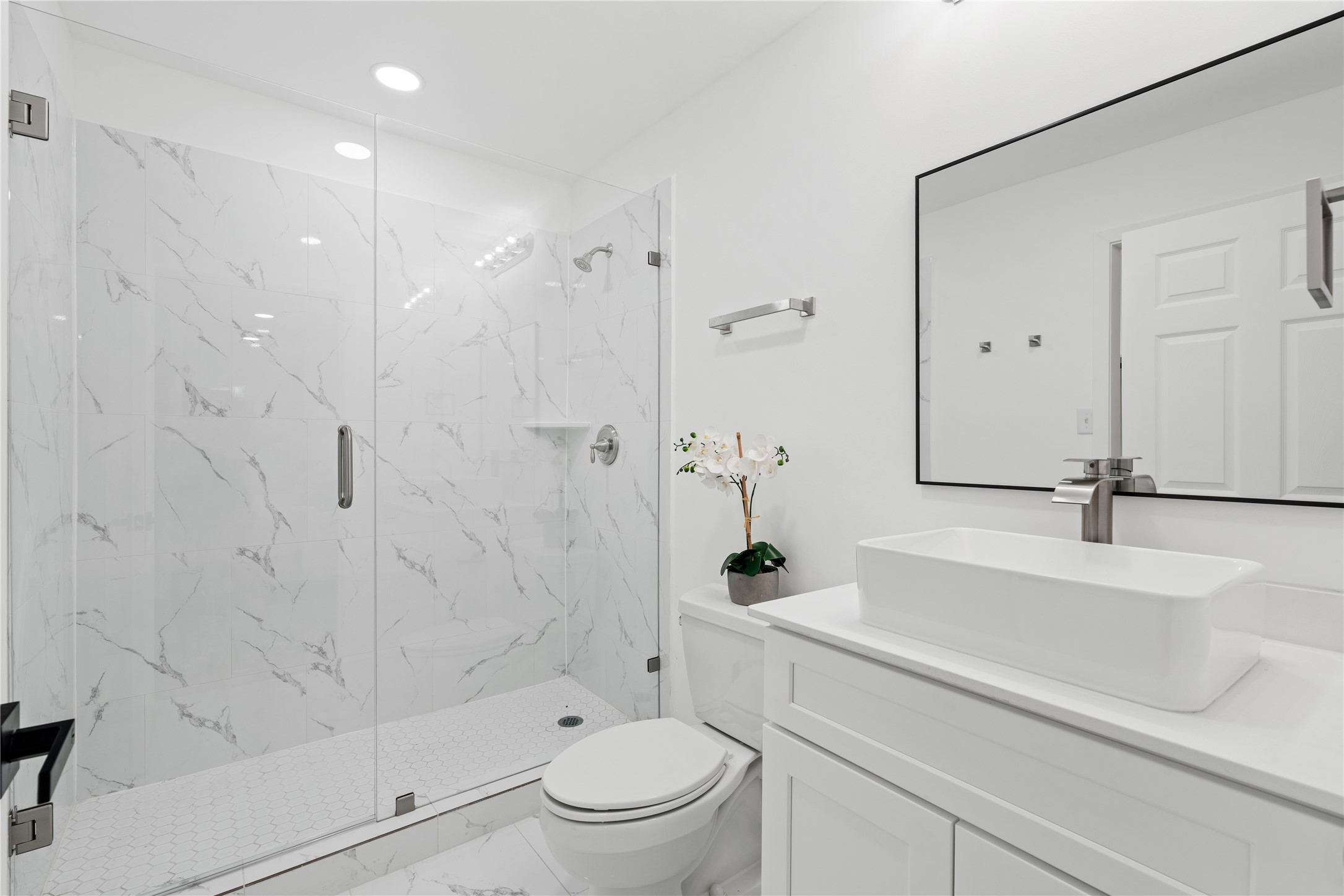 4427 Sanford Road Houston, TX 77035 - Photo 19 of 28 a bathroom with a sink a toilet and a shower