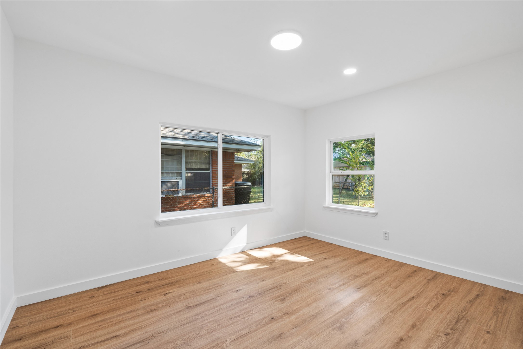 4427 Sanford Road Houston, TX 77035 - Photo 21 of 28 an empty room with wooden floor and windows