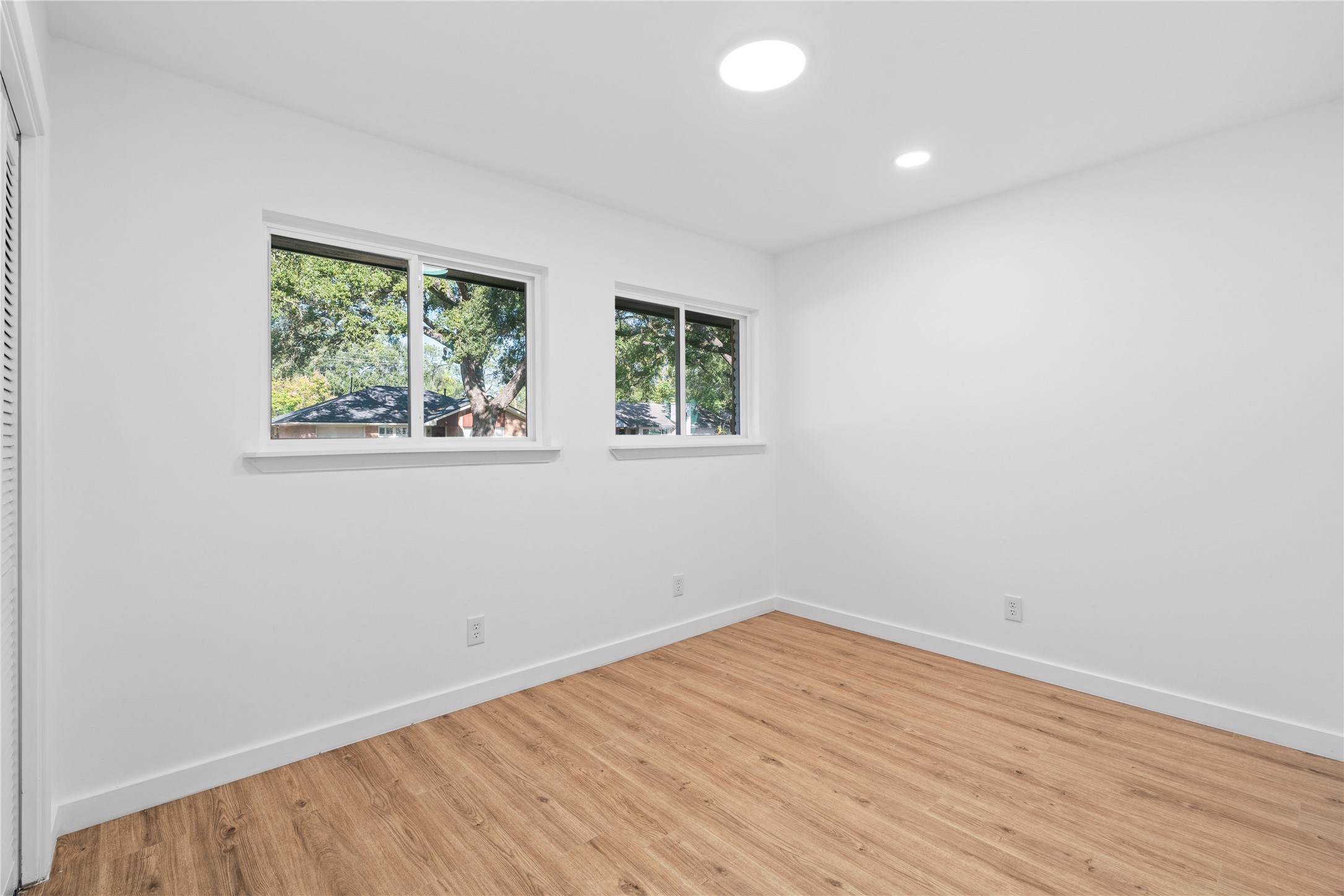 4427 Sanford Road Houston, TX 77035 - Photo 25 of 28 an empty room with wooden floor and windows