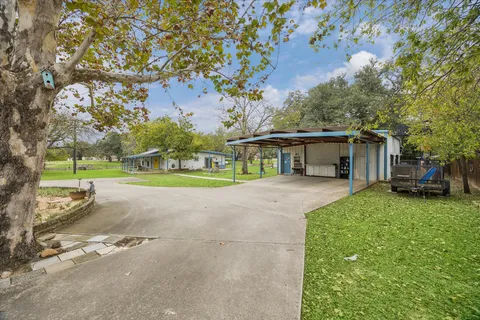 a view of a house with a yard and garage