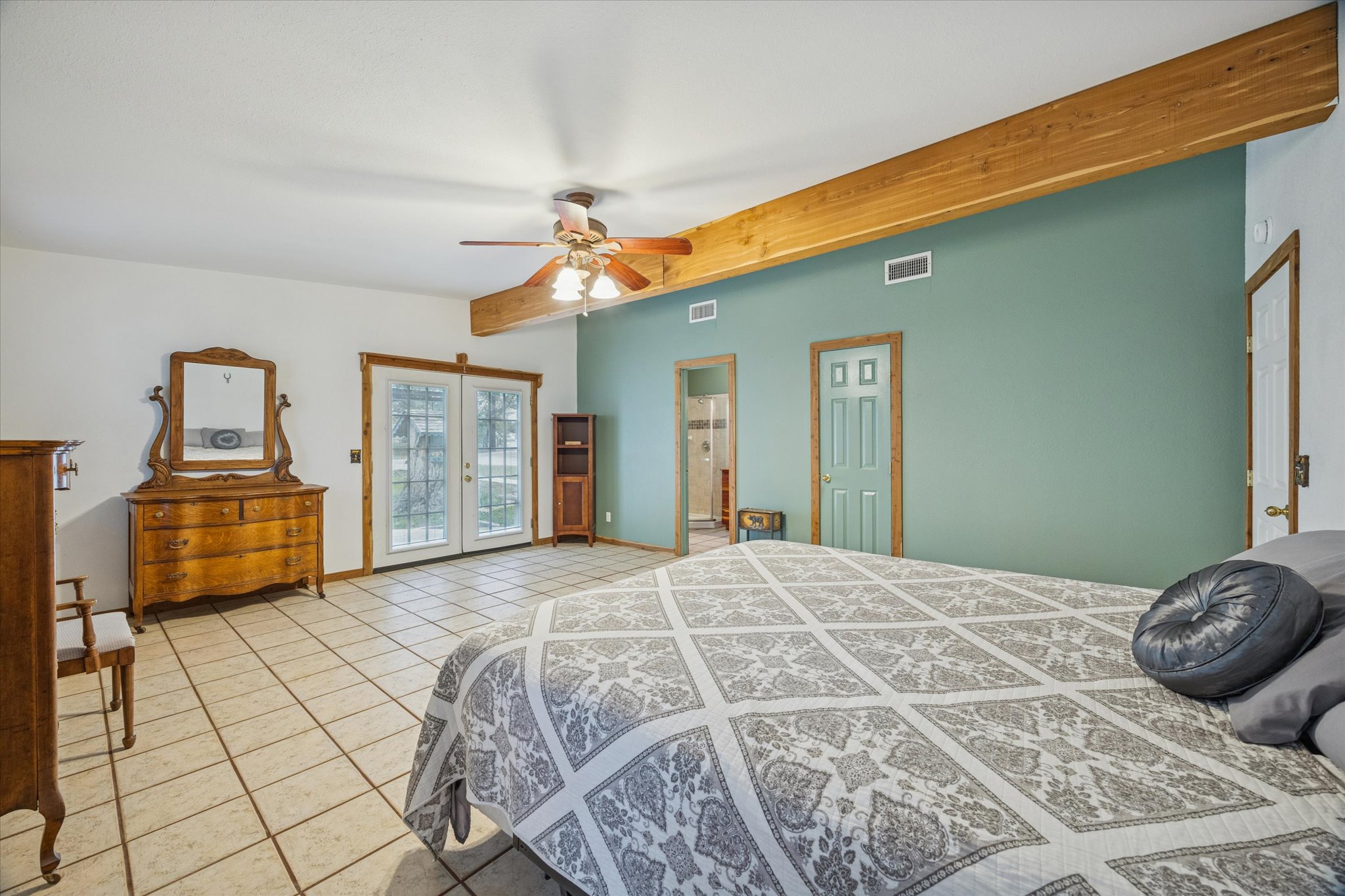 3502 1869th Ranch Liberty Hill, TX 78642 - Photo 14 of 18 Bedroom with light tile patterned floors, beamed ceiling, access to exterior, ceiling fan, and french doors