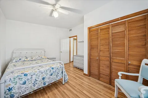 a bedroom with a bed and wooden floor