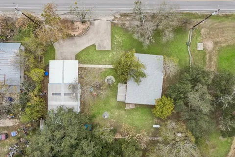 an aerial view of residential house with outdoor space and swimming pool
