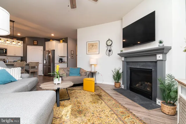 a living room with furniture and a fireplace