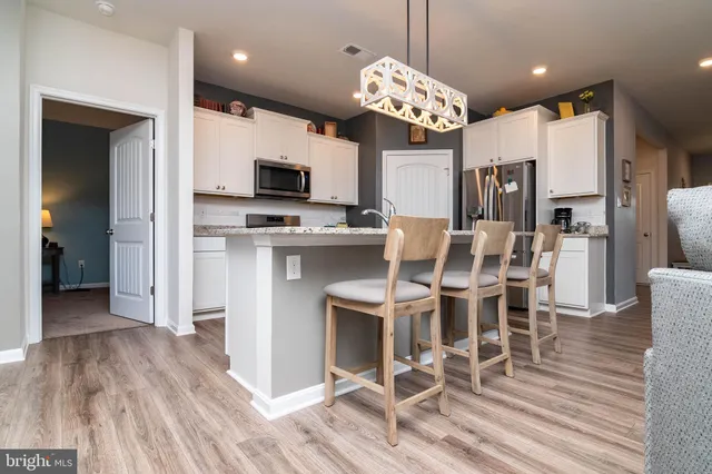 a view of a dining room with furniture wooden floor and chandelier