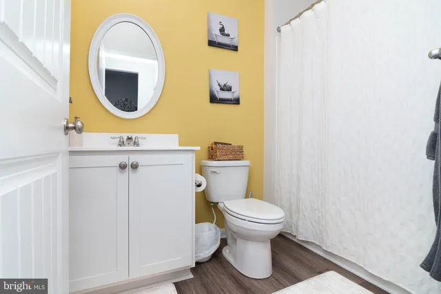 a bathroom with a toilet sink and mirror