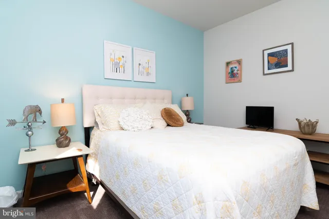 a bedroom with a bed and a table in it