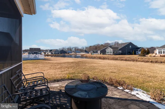a view of a lake with table and chairs
