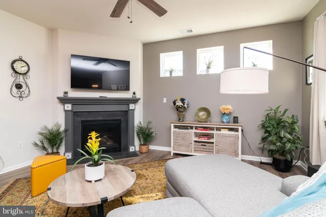 a living room with furniture and a fireplace