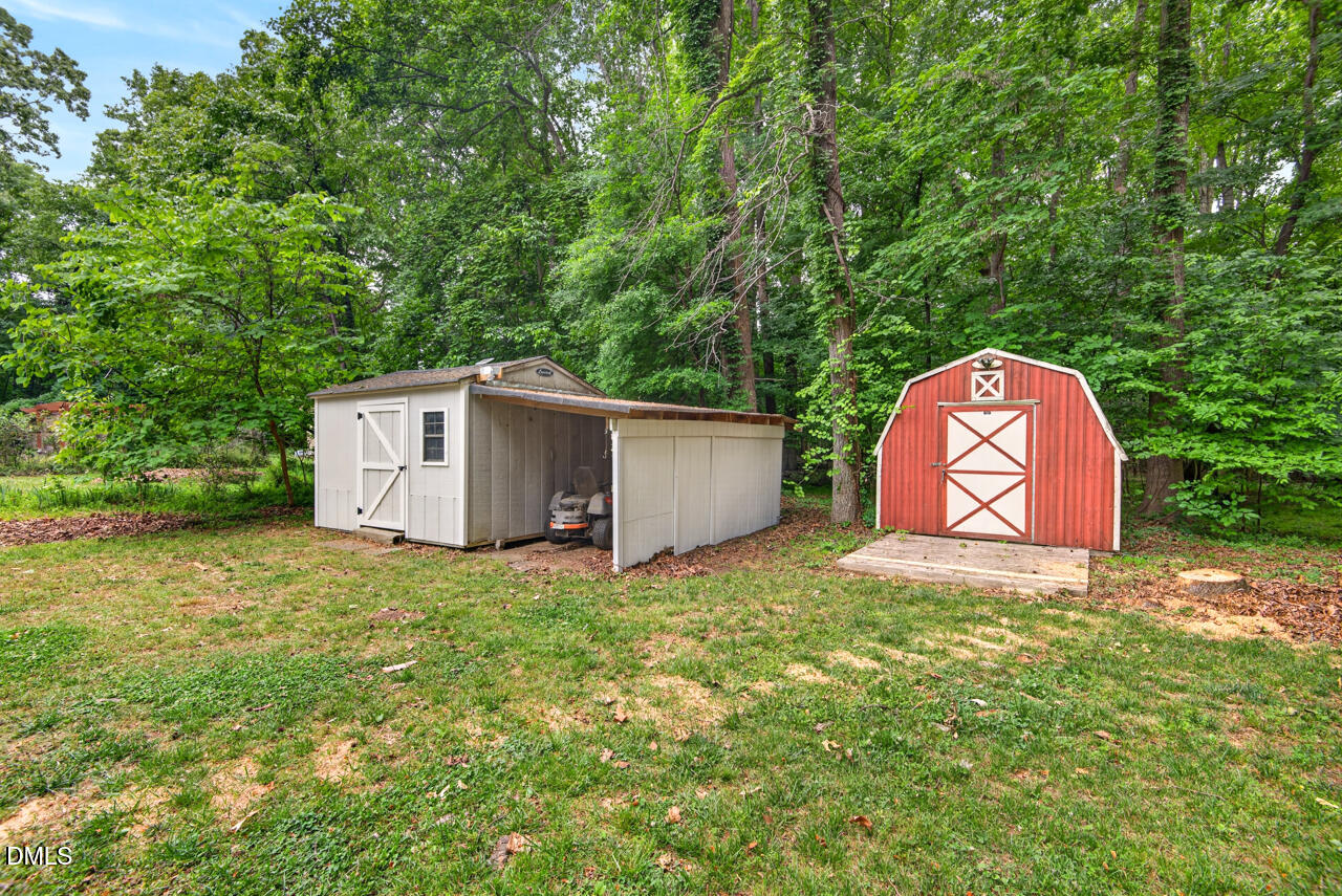 1420 Goodwin Road Durham, NC 27712 - Photo 39 of 54 a backyard of a house with a garden and deck