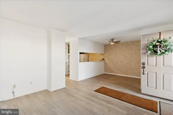 an empty room with wooden floor and cabinet