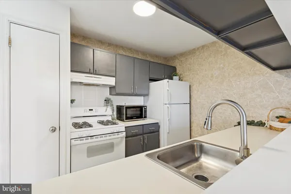 a kitchen with a sink cabinets and stainless steel appliances