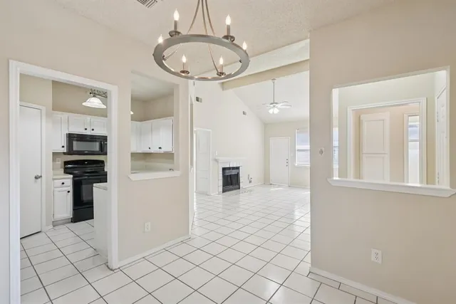 a kitchen with granite countertop a stove sink and cabinets
