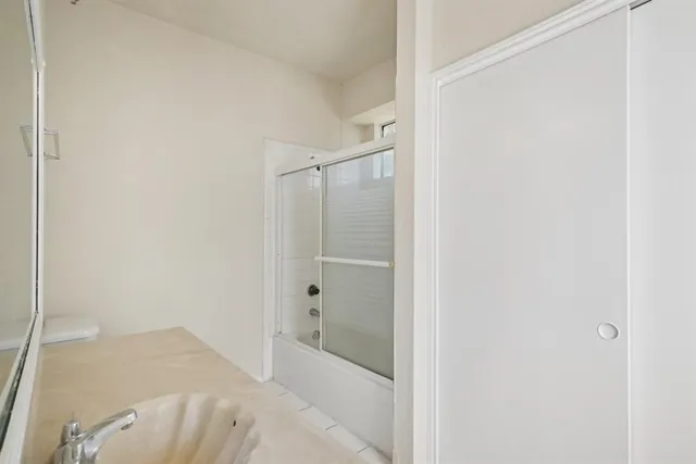 a bathroom with a glass shower door