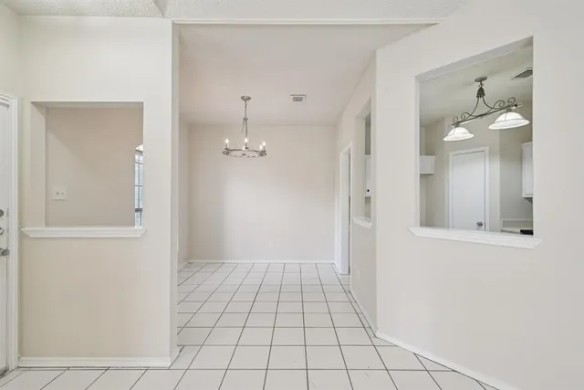 a view of an empty room with window and fireplace
