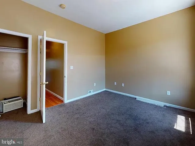 a view of an empty room with a kitchen