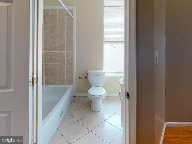a bathroom with a toilet and a bathtub