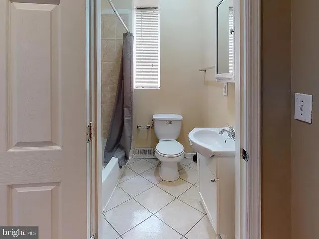 a white toilet sitting next to a bathroom sink