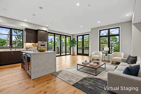a living room with furniture and large windows