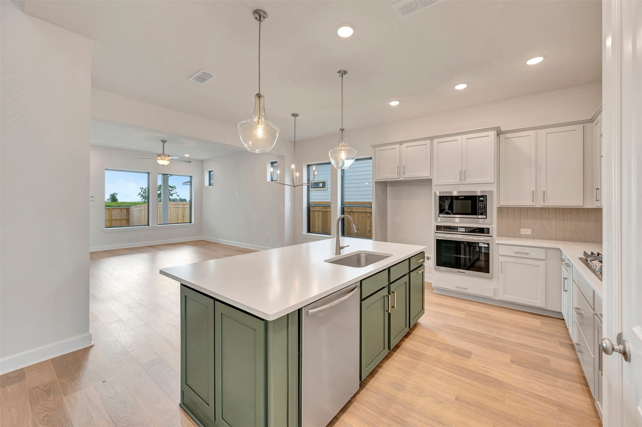 2718 Cottage Place Rosharon, TX 77583 - Photo 18 of 50 a kitchen with kitchen island a sink stove and oven