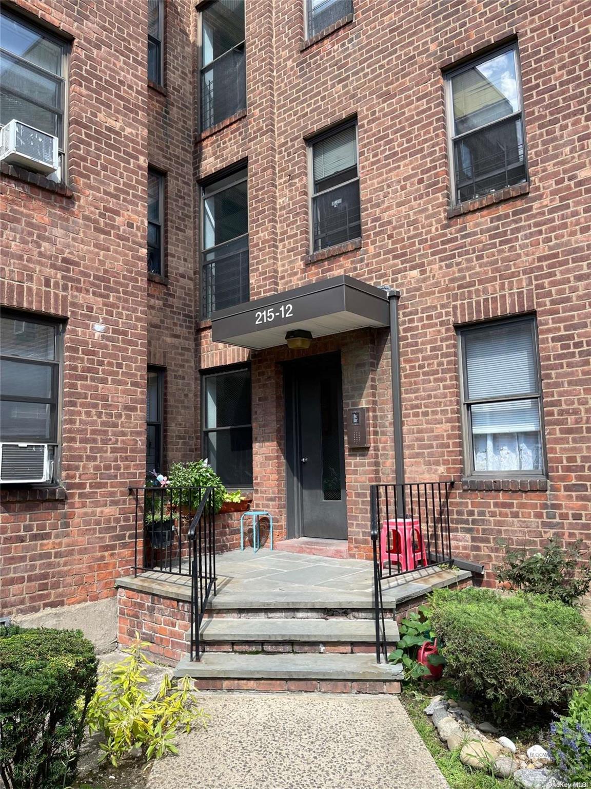 215-12 47th Avenue, Unit 1D Queens, NY 11361 - Photo 1 of 1 a view of a house with potted plants and a tv