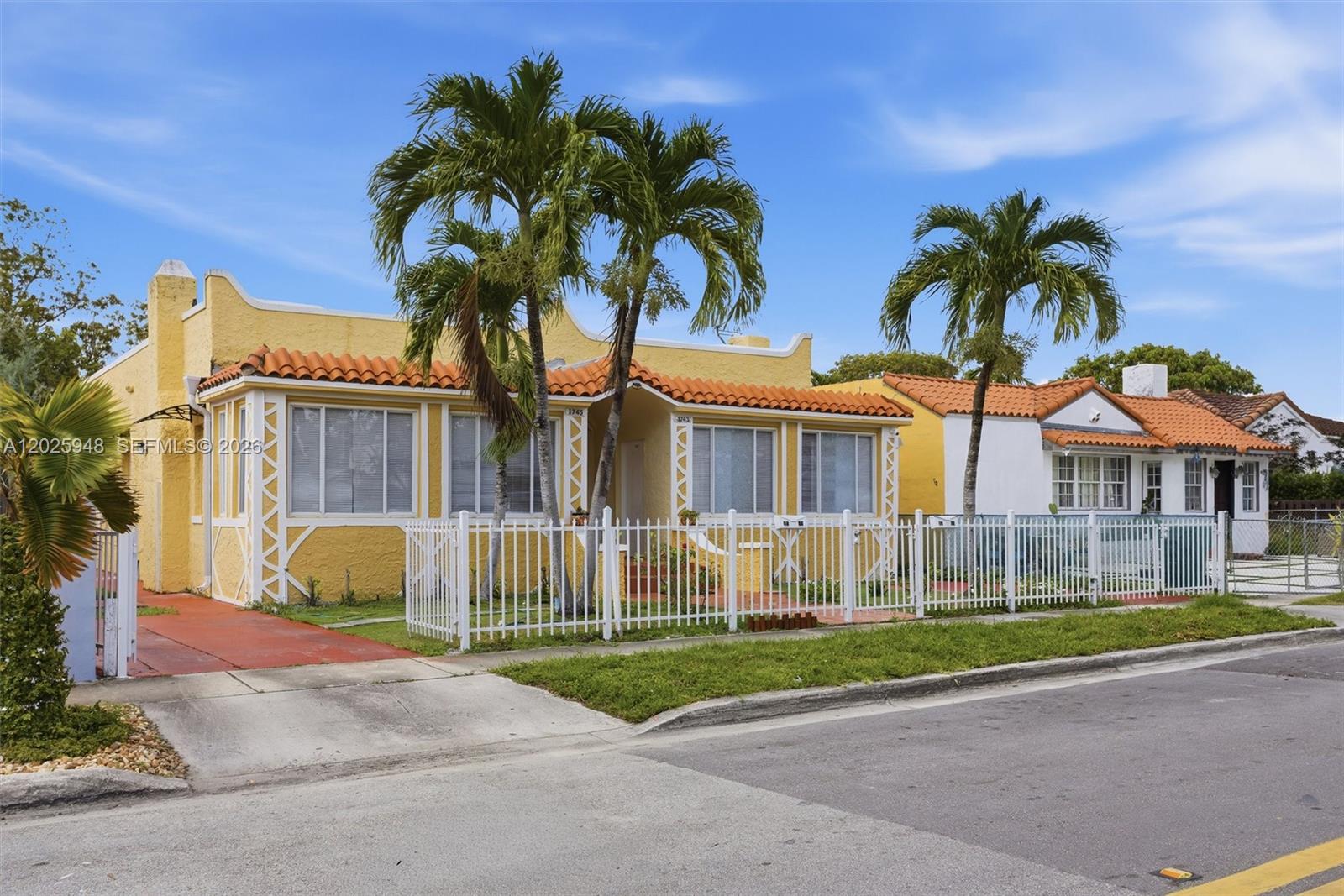 1745 Southwest 17th Street, Unit 2 Miami, FL 33145 - Photo 2 of 32 a view of a house with a yard and palm trees