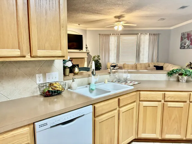 a kitchen with a refrigerator and a stove top oven